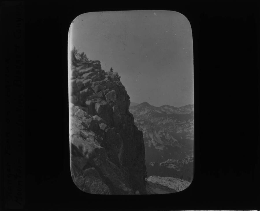 The glass slide reads: 'Ranger Fenn on Shattuck Mountain overlooking Blodgett Canyon.'