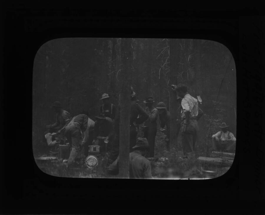 The glass slide reads: 'Firefighters at dinner, Lolo Hot Springs.'