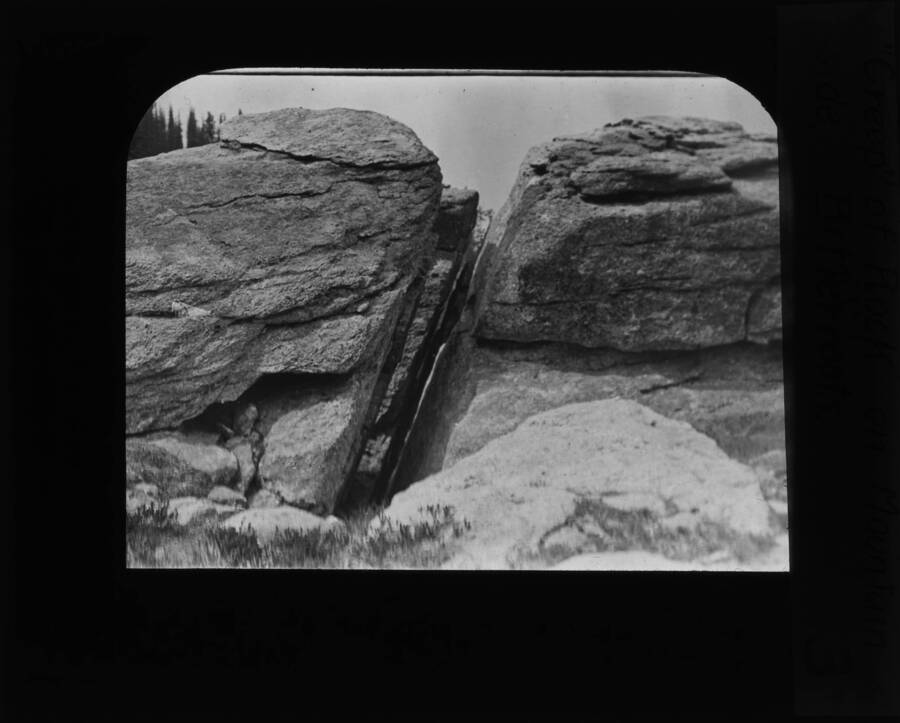 The glass slide reads: 'Creep of rock on mountain side, Bitterroots.'
