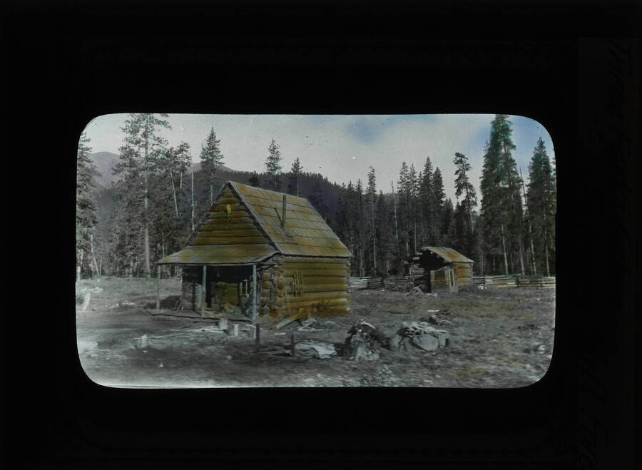 The glass slide reads: 'Three Forks Cabin, Selway National Forest.'