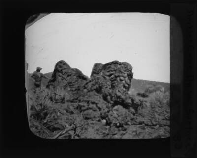An unidentified person leans on a driblet cone. The glass slide reads: 'Driblet Cone On "aa" Surface.'