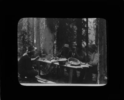 The glass slide reads: 'Forest rangers at dinner - White Sand Lake.'