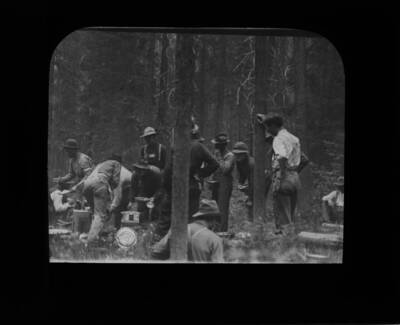 The glass slide reads: 'Trench gang, Firefighters at dinner.'