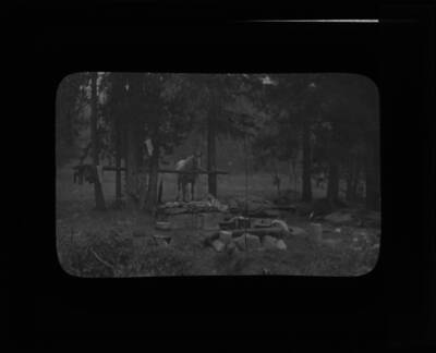The glass slide reads: 'Camp at Powell, Idaho, Fires, 1910.'