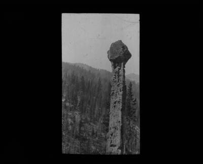 Tall, skinny shaft of rock rising from the bottom of a basin. The glass slide reads: 'Hoodoo in Bryce Canyon National Park, Utah.'