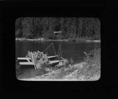 The glass slide reads: 'Ferrying horses over the Lochsaw River at the Forks. (Rangers Fitting, Fenn, and Weholt).'