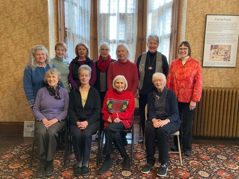 Group photograph of the 2023 Pleiades Club members. Front: Cathy Willmes, Terry Peterson, Peggy Conrad, Mary Reed. Back: Andrea Fountain, Nancy Sasser, Nancy Lyle, Helen Boisen, Prudy Heimsch, Denise Thomson, Harriet Hughes. Not pictured:  Kathy Barnard-LaPointe, Barbara Meldrum, Nancy Ruth Peterson.