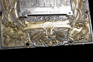 Close up detail of jewelry box cover featuring golden relief of scroll that is etched with the words "Idaho the Gem of the Mountains"