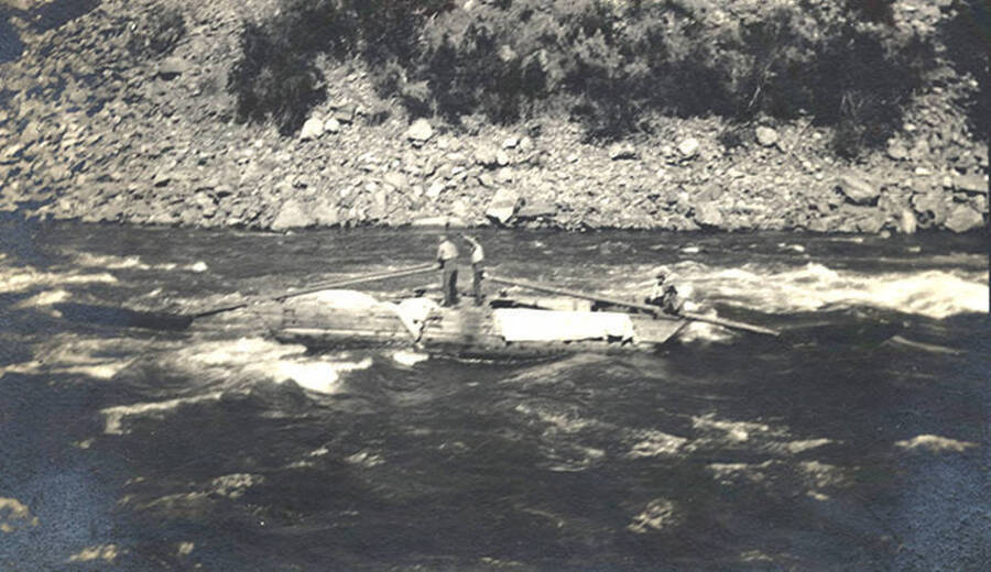 Scow with two sweeps on river rapids on the South Fork of the Clearwater River.