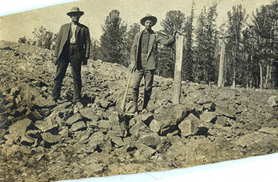 Schofield and Riggs stand in scree field at Thunder Mountain.