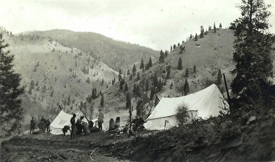 View of the camp with tents and men in the Chamberlain Basin.