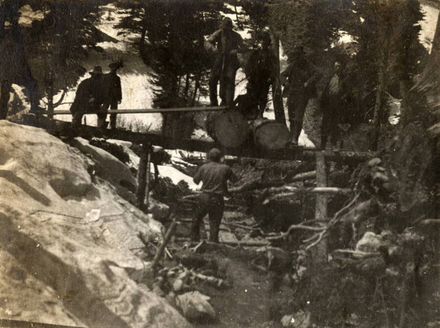 A group of men work with a whipsaw in a snowy area near Thunder Mountain.