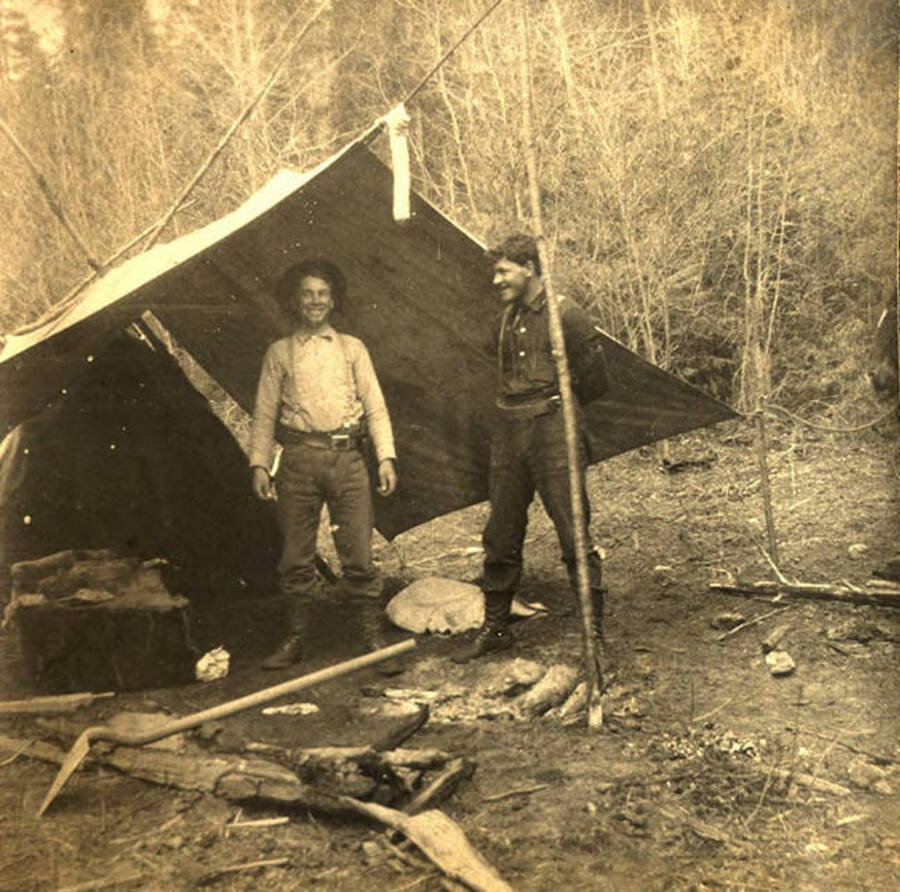 Earl Clayton (right) and Sumner "Governor" Stonebraker (left) pose near a tent. The photo caption reads: 'Now laugh if you wish.'
