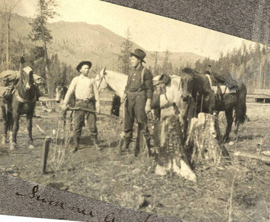 Sumner Stonebraker and Earl Clayton stand with pack horses near the Stonebraker Ranch in the Chamberlain Basin.