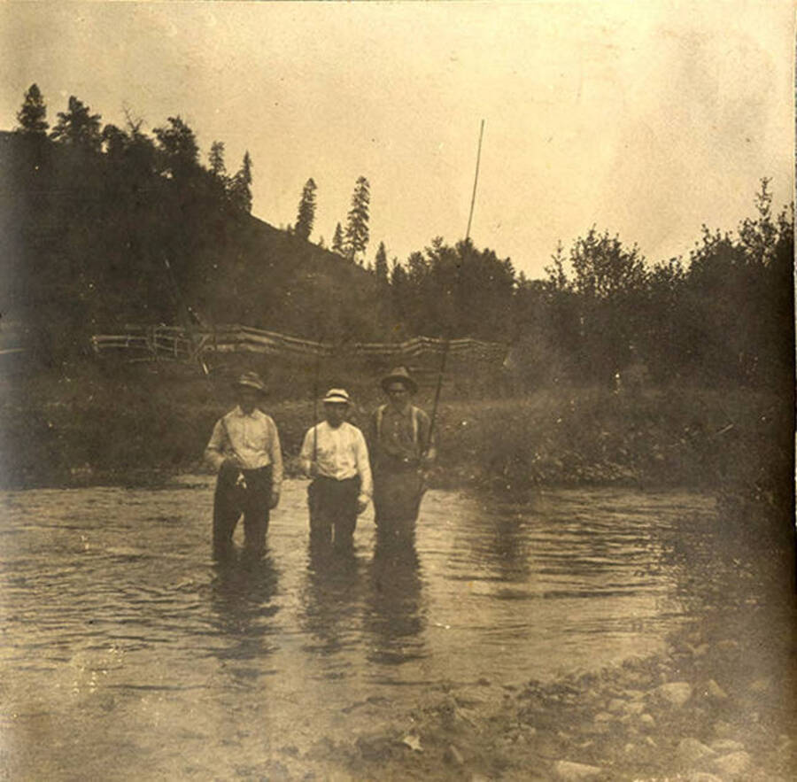 W. A. Stonebraker, Dr. J. M. Woodburn, and Sumner (Governor) Stonebraker pose with fishing rods in the Clearwater River.