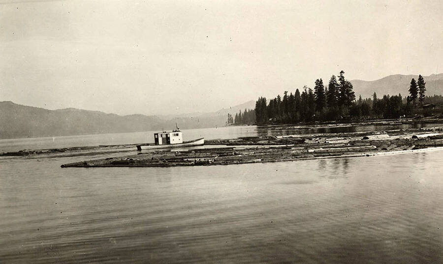 A tugboat sits among logs in Payette Lake near McCall.