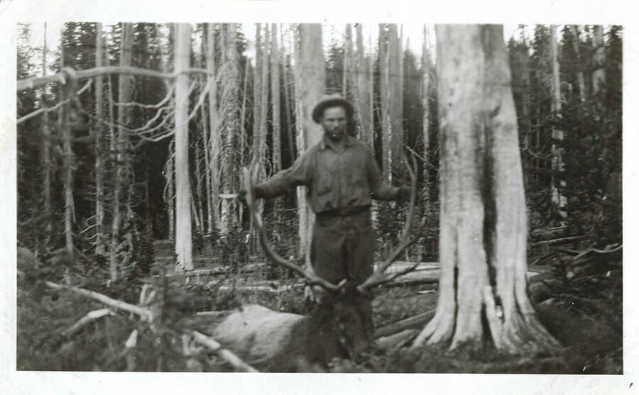 W. A. Stonebraker holds the antlers of a harvested bull elk.