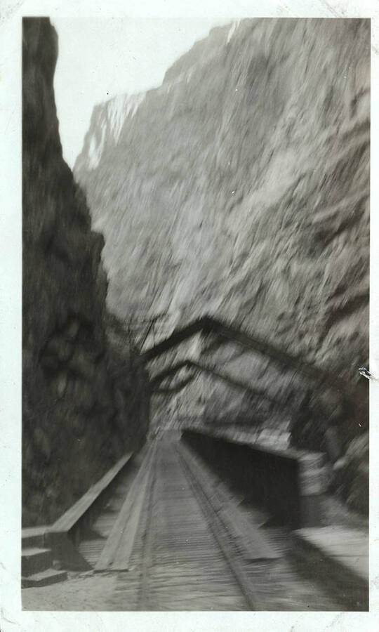 Railroad tracks across a bridge above the river canyon.