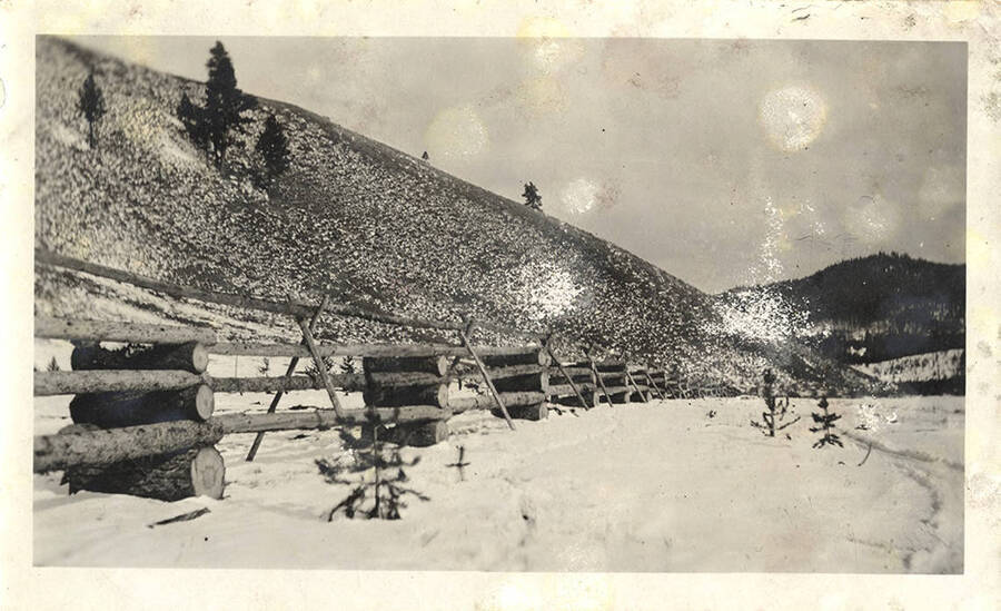 A log fence in the snow provides a perimeter at the Stonebraker Ranch.