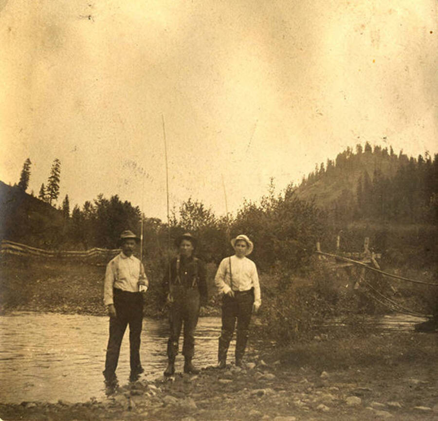 W. A. Stonebraker, Dr. J. M. Woodburn, and Sumner (Governor) Stonebraker pose with fishing rods near the Clearwater River.