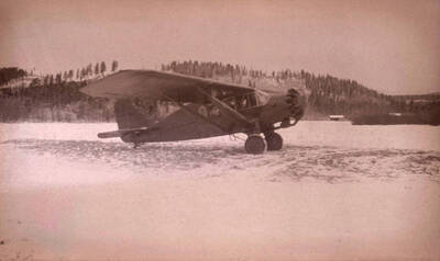 An airplane parked in a snowy meadow near Stonebraker Ranch in Chamberlain Basin.