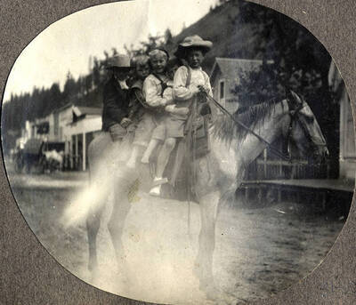 Three children sit atop a horse on the main street in Stites, Idaho.