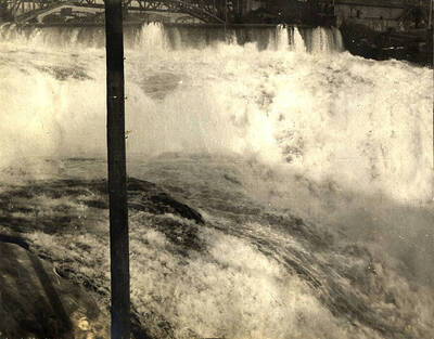 Looking north towards the falls. The second Monroe Street Bridge made out of steel is in the background.