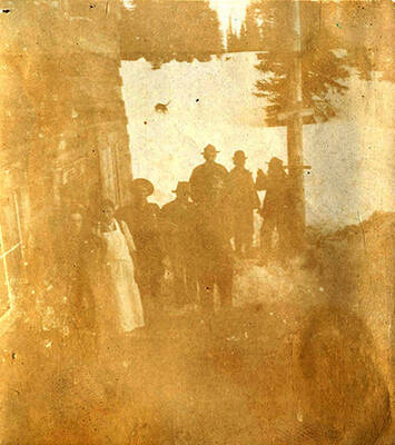 Men and women pose outside a cabin near Roosevelt, Idaho.