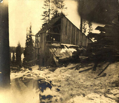 Mill building being constructed in the snow near Thunder Mountain.