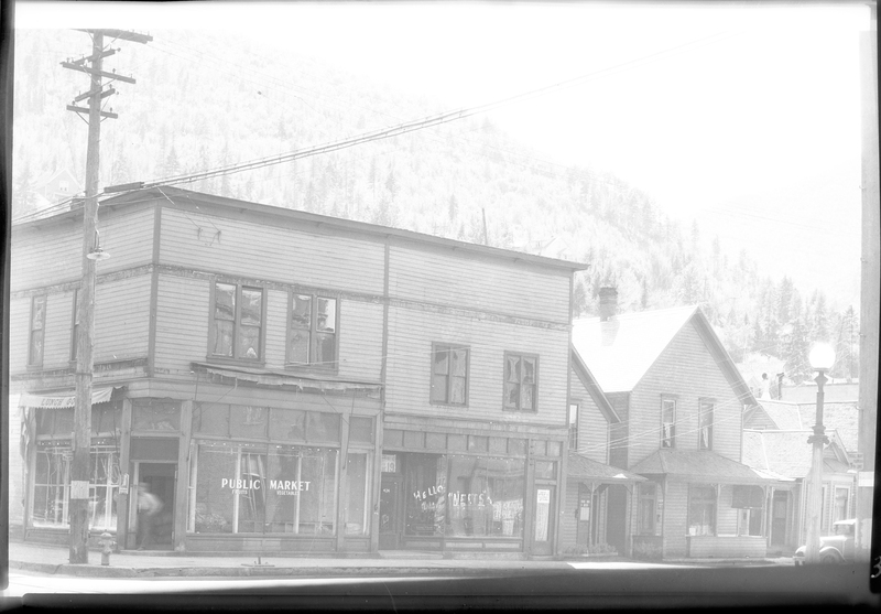 Photo of the Public Market building. The negative is overexposed and makes the image extremely washed out, but the building and houses next to it are visible.