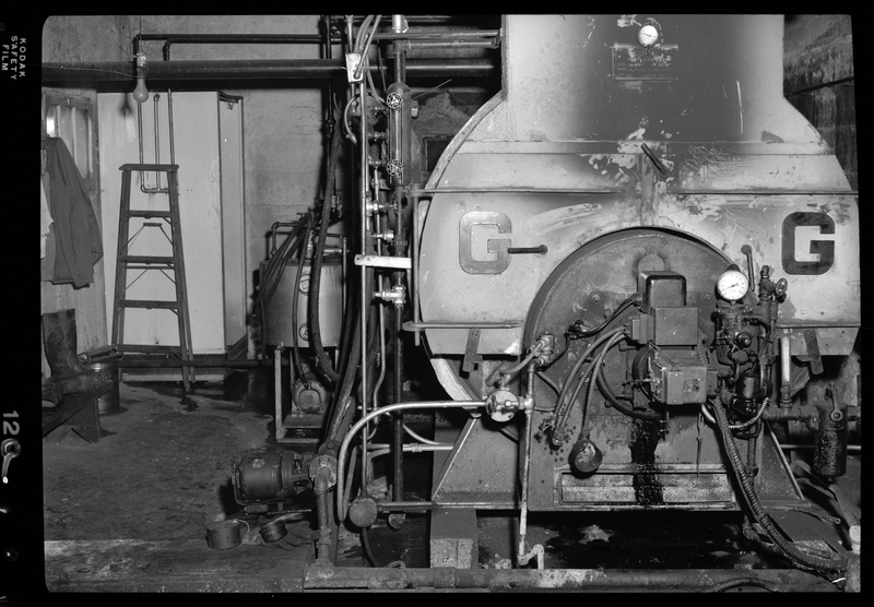 Photo of a large piece of machinery inside the Wallace Meat Company building. The machine is not labeled as to what it is or what it does.