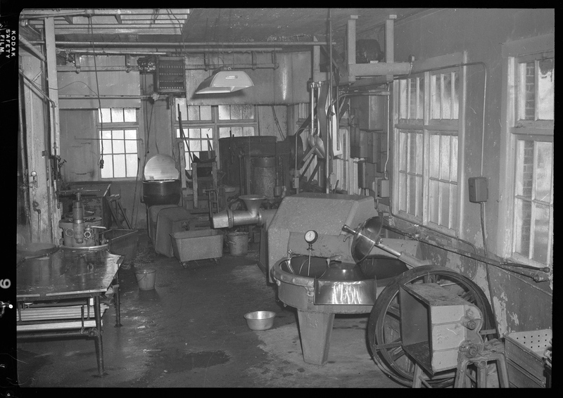 Photo of various pieces of machinery and a workbench inside the Wallace Meat Company building.