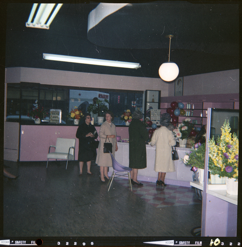 Photo of the interior of Beauty Marte during its store opening. Color photo of several women standing in line at the front counter of the store.