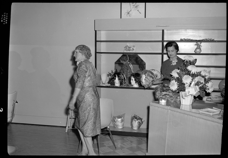 Photo of two unidentified women inside of Beauty Marte during its store opening. One woman is standing behind the counter and the other is walking away.