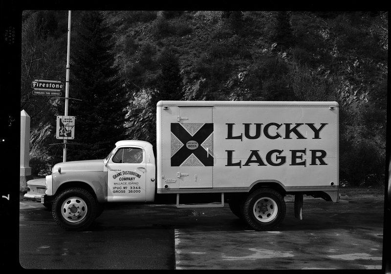 Photo of a Grant Distributing Company truck with a "Lucky Lager" beer decal on the side of it. It is parked on the side of the road for pictures.