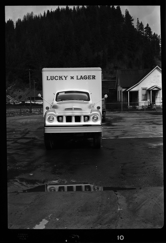 Photo of a Grant Distributing Company truck with a "Lucky Lager" beer decal on the front of it. It is parked on the side of the road for pictures.