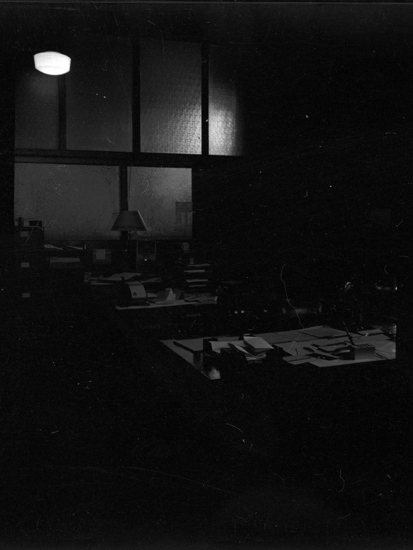 Photo of the interior of an unidentified office. The photo is extremely dark and very little detail can be made out.