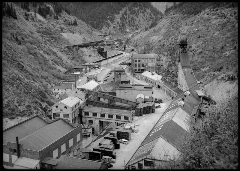 Overhead view image of Hecla Mining Company facilities at the Star Mine in Burke, Idaho. Several buildings are visible, many of which are connected to each other, as well as some cars parked throughout the area.