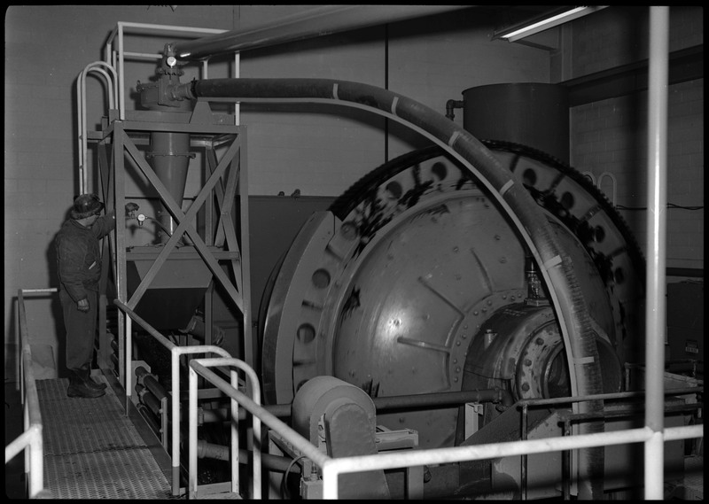The Lucky Friday Mine cylinder mill machine and a man who is operating it.