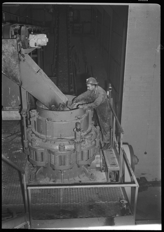 A man working inside of the Lucky Friday Mine. He appears to be operating the milling equipment.