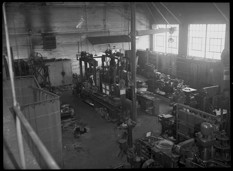 Image of the underground facilities and equipment at Hecla Mine. The room is filled with various machinery, however the windows on one side of the room suggests that this room is not underground.