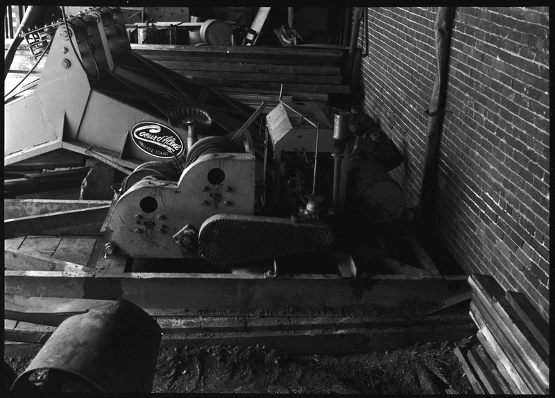 Mining equipment used by Coeur d'Alene Mining Company. The photo is of the side of a machine, revealing the logo to read, "Coeur d'Alene; Wallace, Idaho."