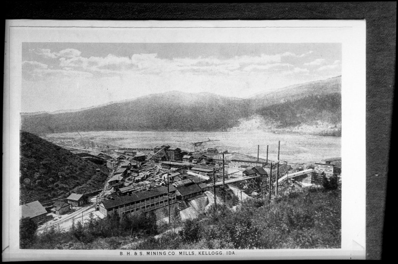 Image of a photo of "B. H. & S. Mining Co. Mills, Kellogg, Ida," as written on the photo. The photo overlooks the Bunker Hill Mill, which is pretty grainy, but the milling complex is mostly visible.