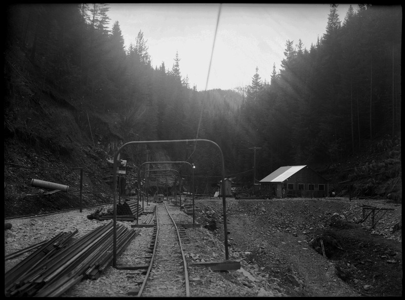 Image of the railroad that leads minecarts into Rock Creek Mine. Notes say that Rock Creek Mine is located 4 miles east of Wallace, Idaho.