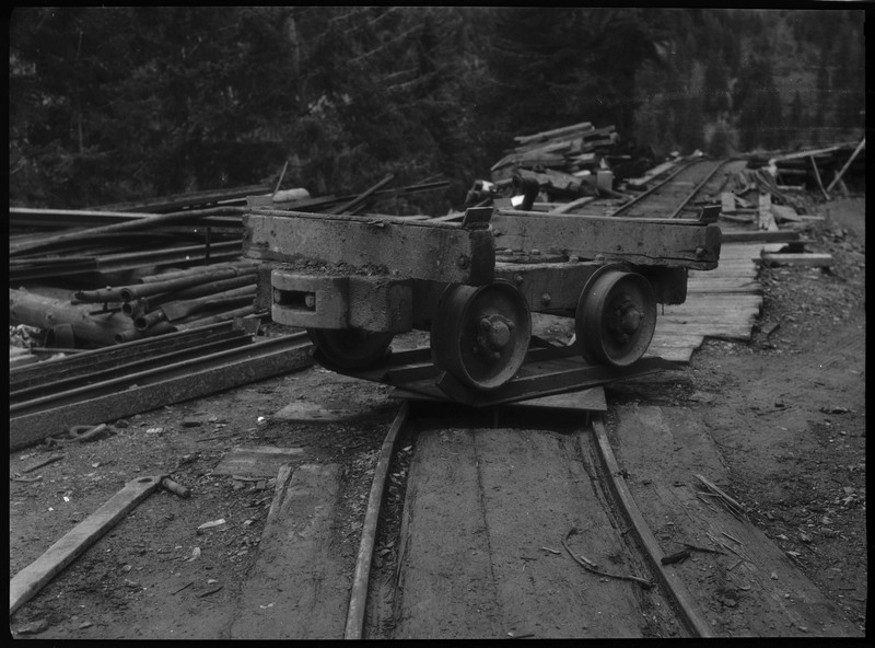 The base of a mine cart, showing just the wheels.
