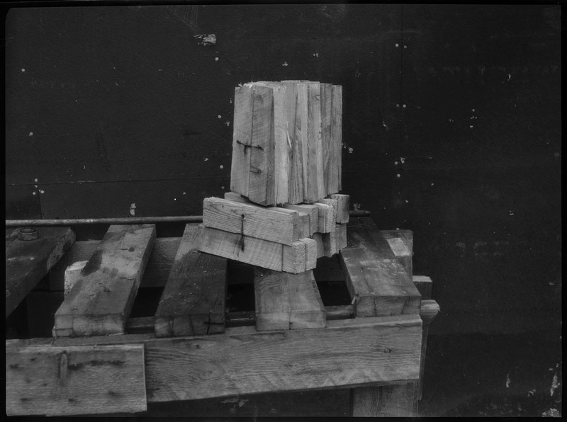 Several cut pieces of wood stacked together, sitting on top of a wooden bench.