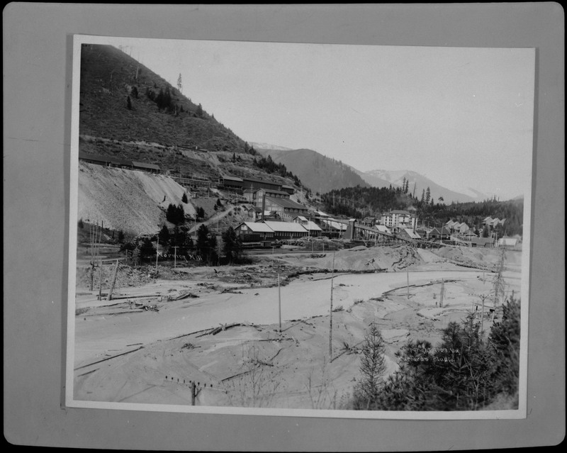 Image of a photograph of Morning Mill in Mullan, Idaho. The photo shows the milling complex and surrounding area, and there is snow on the ground.
