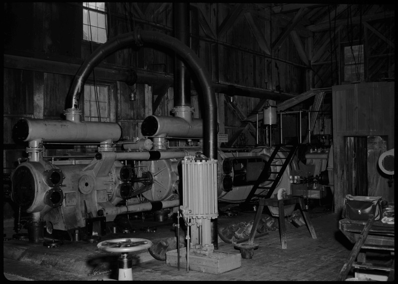Image of the Morning Mine Compressor (Grouse Gulch) in Mullan, Idaho. It is a large piece of machinery within the mine.
