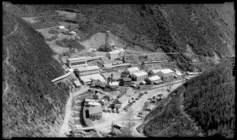 Image overlooking the Sunshine Mine complex in Big Creek, Idaho. The whole mining complex is visible including buildings and trucks.