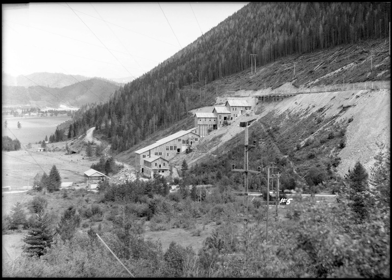 Silver Summit mine from a distance. The entire complex is visible with buildings going up a hill that is covered in trees.